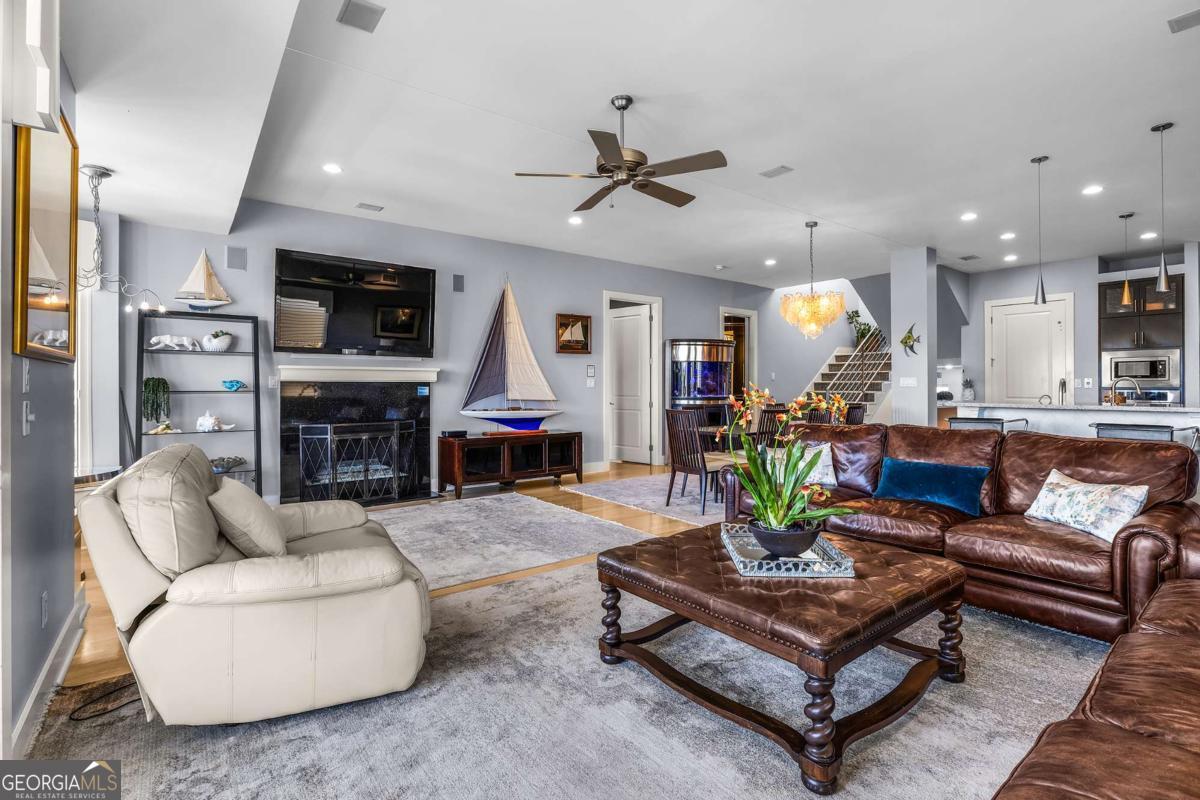 8 18th Street Tybee Island, GA 31328 - Photo 26 of 50 a living room with furniture a fireplace and a flat screen tv