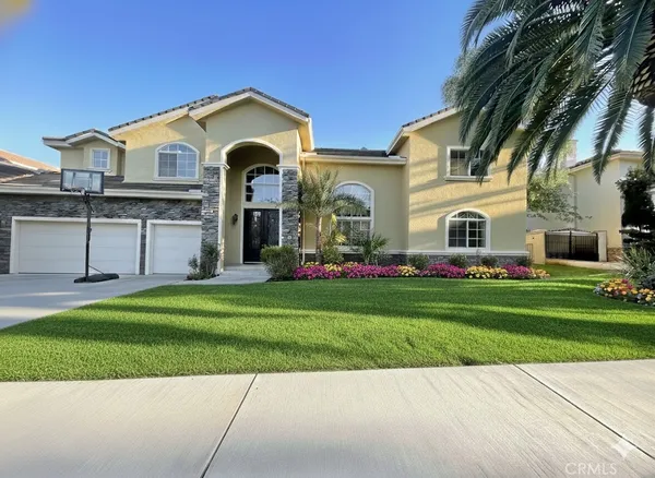 a front view of house with yard and green space