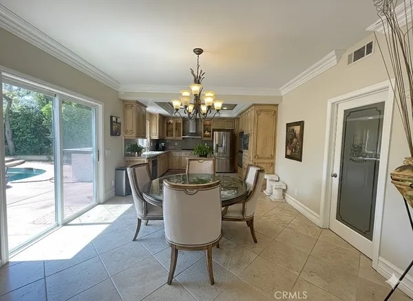 a dining room with furniture a chandelier and a rug