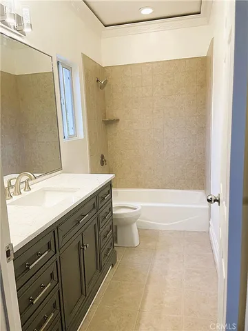 a bathroom with a granite countertop sink a mirror and a bathtub