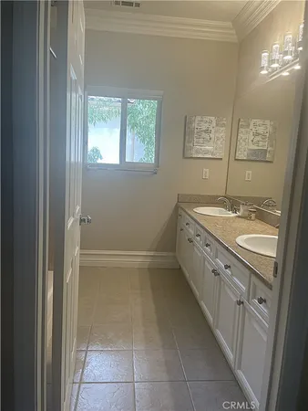 a utility room with cabinets washer and dryer