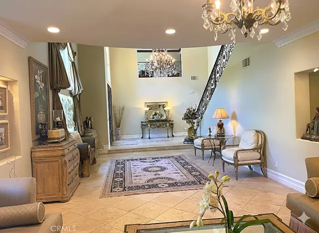 a living room with furniture and a chandelier