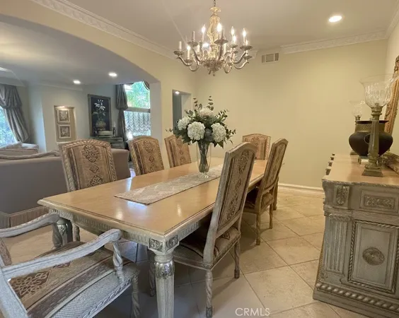 a view of a dining room with furniture and chandelier