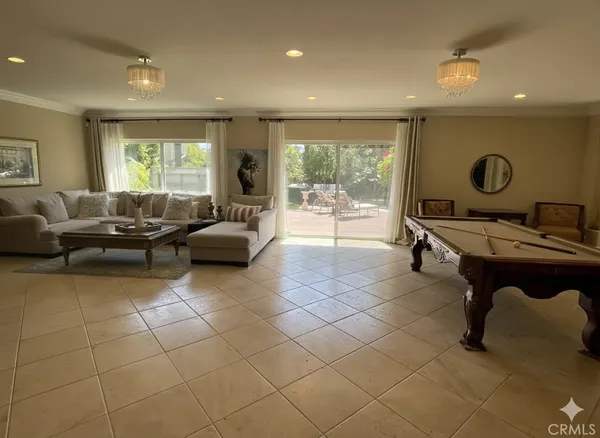 a living room with furniture a large window and white walls