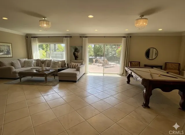 a living room with furniture a large window and white walls