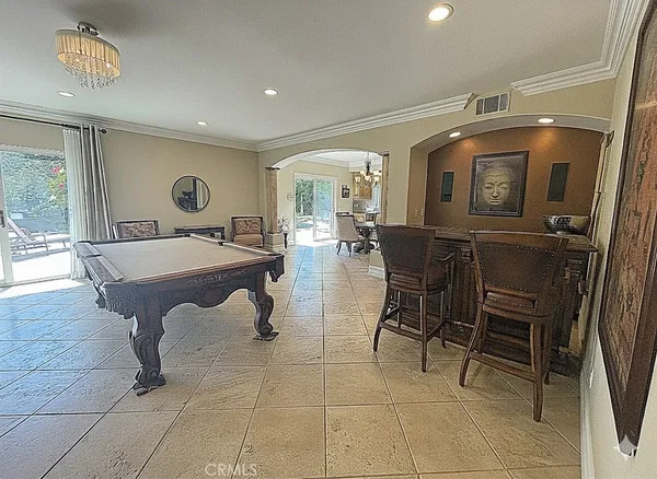 a living room with a table and chairs