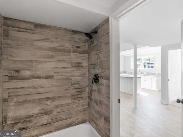 a bathroom with a toilet a sink a mirror and a window