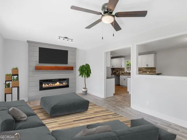 a kitchen with stainless steel appliances white cabinets and a stove top oven