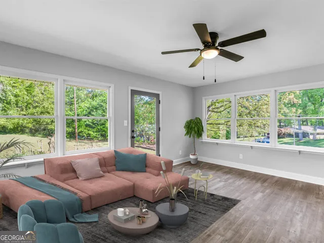 a living room with furniture and view of kitchen