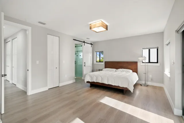 a bedroom with a bed and a chandelier