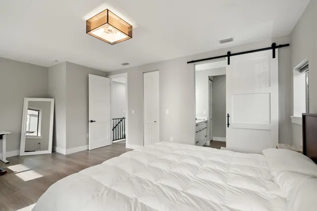 a bedroom with a bed and a chandelier