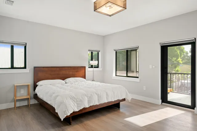 a bedroom with a large bed and a window