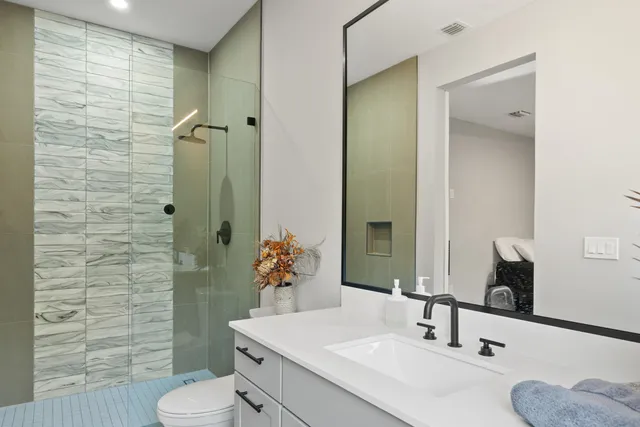 a bathroom with a sink toilet and shower