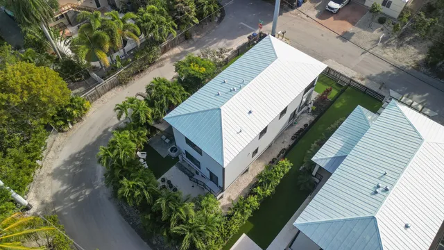 an aerial view of a house with a yard