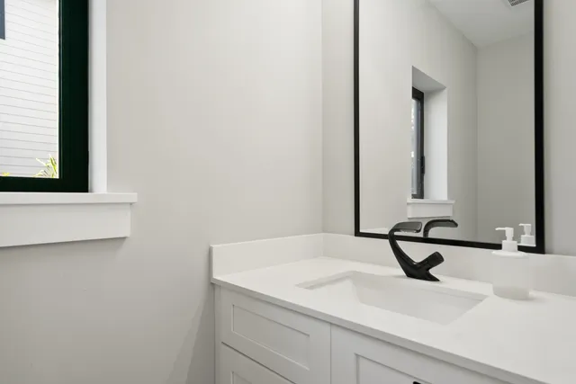 a bathroom with a sink and a mirror