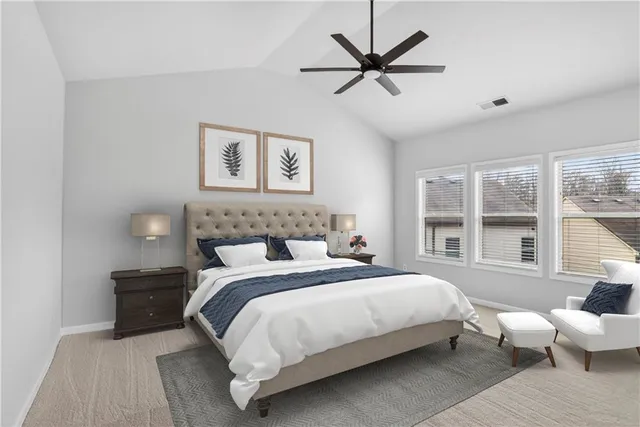 a bedroom with a bed and a large window