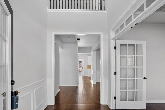 a view of a hallway with wooden floor and staircase