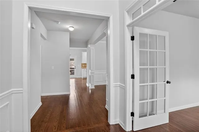 a view of a hallway with wooden floor and staircase