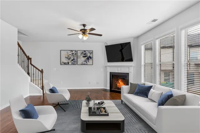 a living room with furniture a fireplace and a flat screen tv