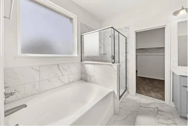 a bathroom with a bathtub and a shower