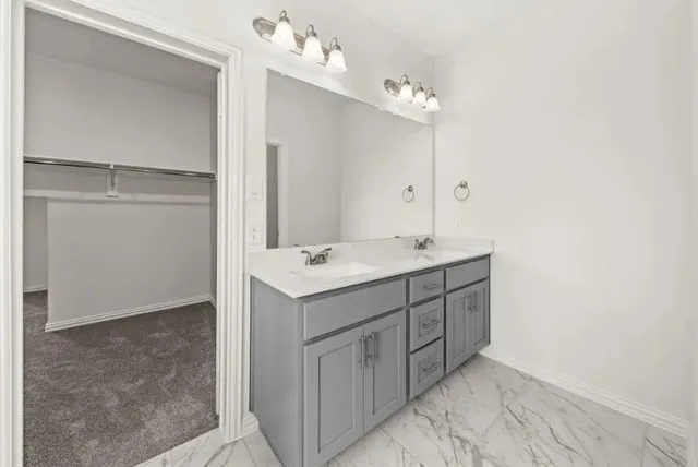 a bathroom with a sink vanity and mirror