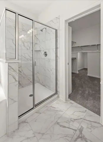 a view of a bathroom with a glass shower door
