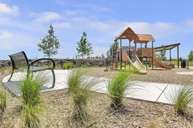 a view of swimming pool with a bench and wooden fence