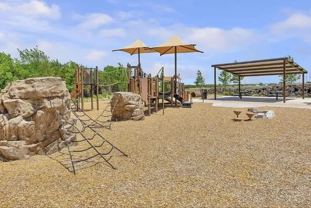 a view of a swimming pool with a patio and a garden
