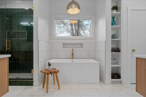 a bed room with a bed and paintings on the wall