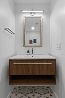 a living room with furniture and a kitchen area