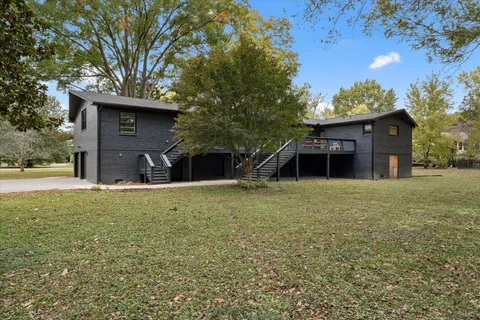 an aerial view of a house with a yard