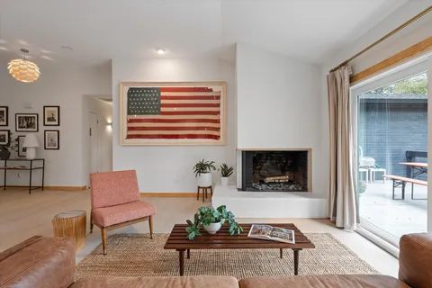 a living room with furniture and a floor to ceiling window