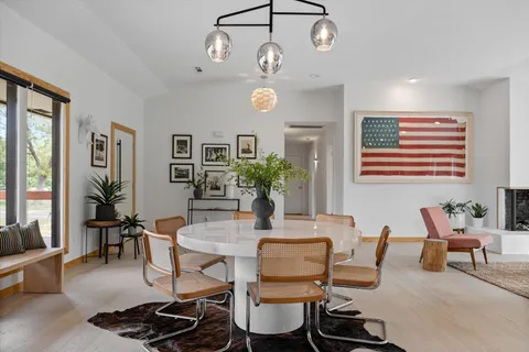 a living room with patio furniture and a potted plant
