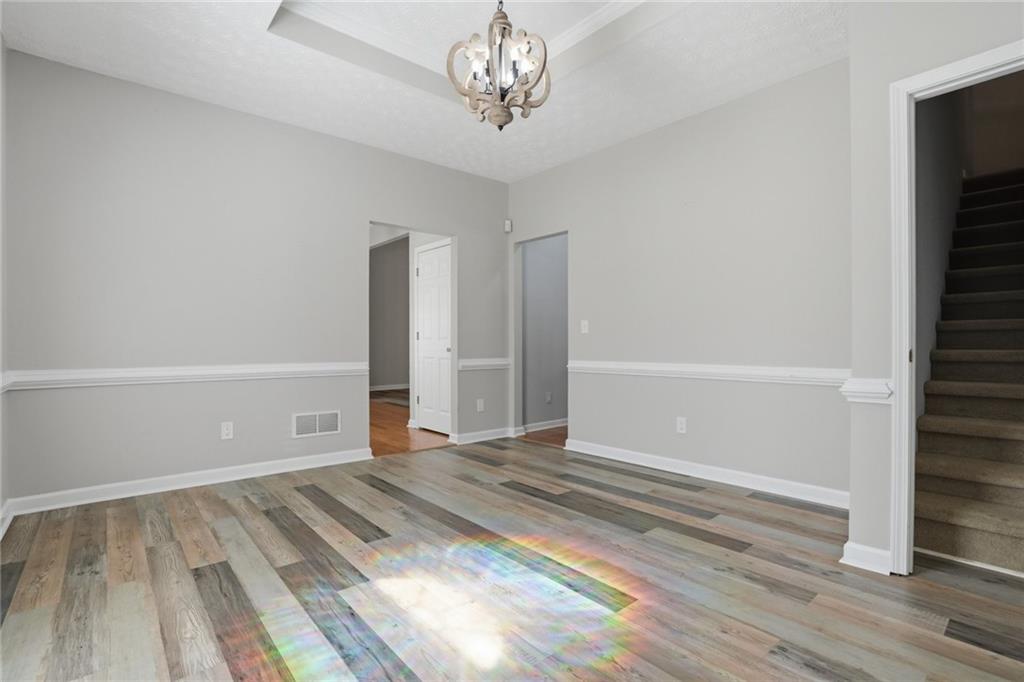 3664 McEver Lake Road Pendergrass, GA 30567 - Photo 11 of 39 a view of an empty room with wooden floor and a window