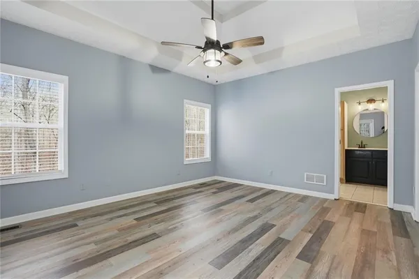 a view of a room with a ceiling fan and window