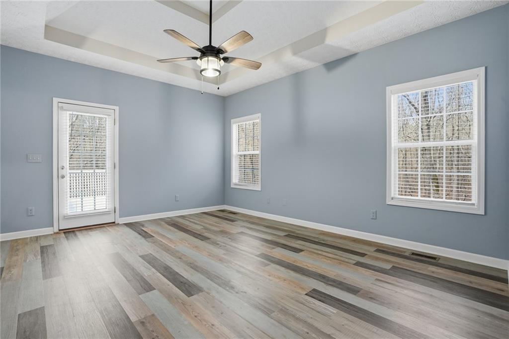 3664 McEver Lake Road Pendergrass, GA 30567 - Photo 13 of 39 a view of an empty room with wooden floor and a window