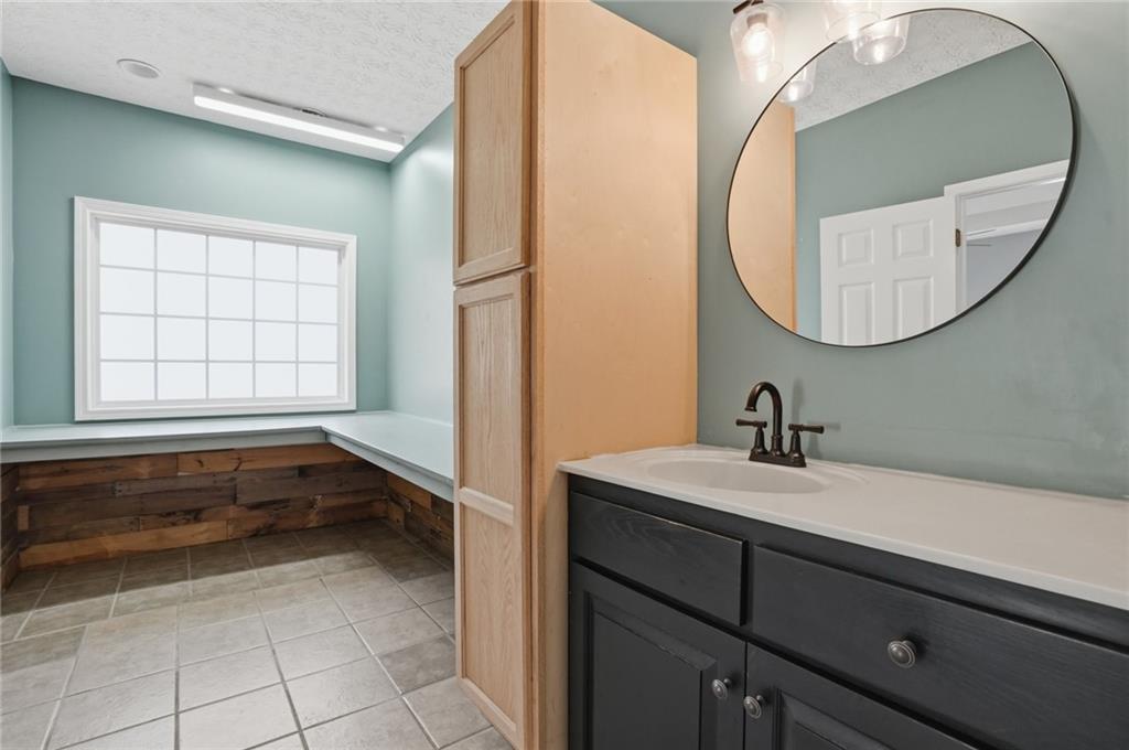 3664 McEver Lake Road Pendergrass, GA 30567 - Photo 15 of 39 a bathroom with a sink and a mirror