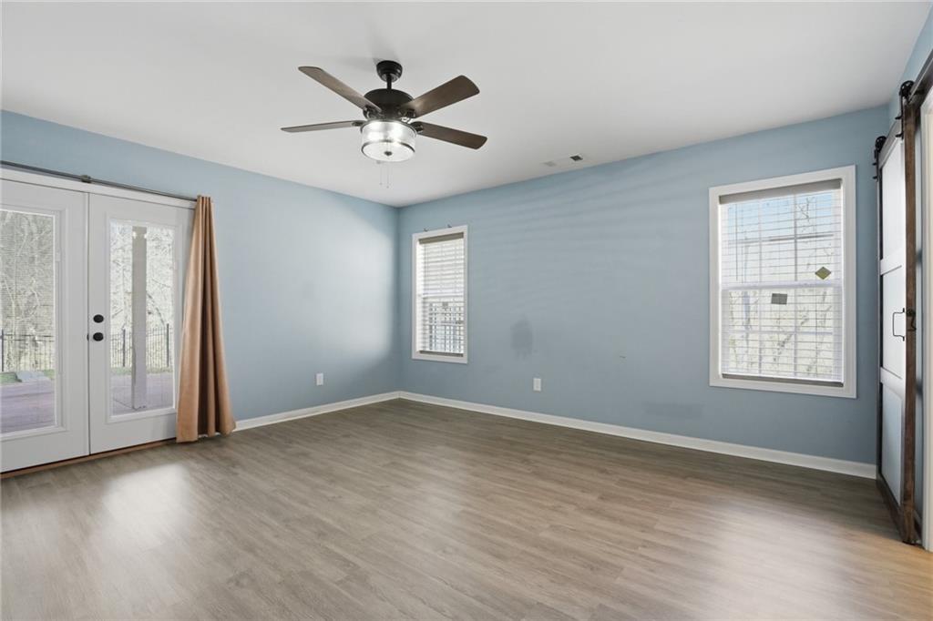 3664 McEver Lake Road Pendergrass, GA 30567 - Photo 22 of 39 a view of an empty room with wooden floor and a window