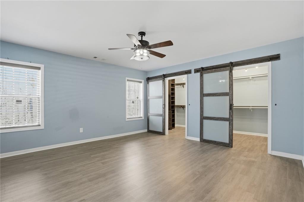 3664 McEver Lake Road Pendergrass, GA 30567 - Photo 23 of 39 wooden floor in an empty room with a window