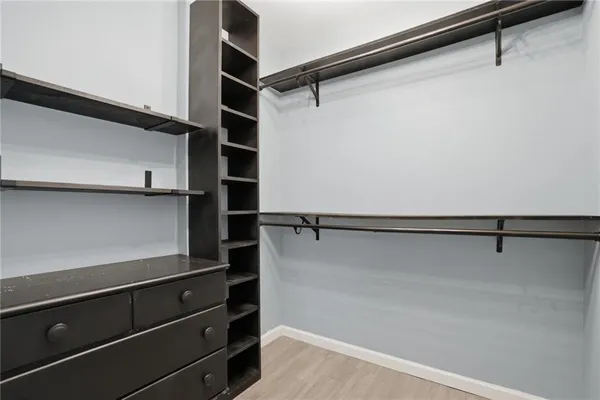 a view of walk in closet with empty racks