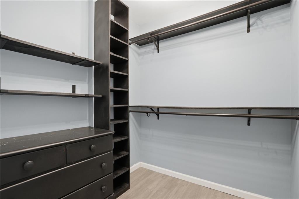 3664 McEver Lake Road Pendergrass, GA 30567 - Photo 24 of 39 a view of walk in closet with empty racks