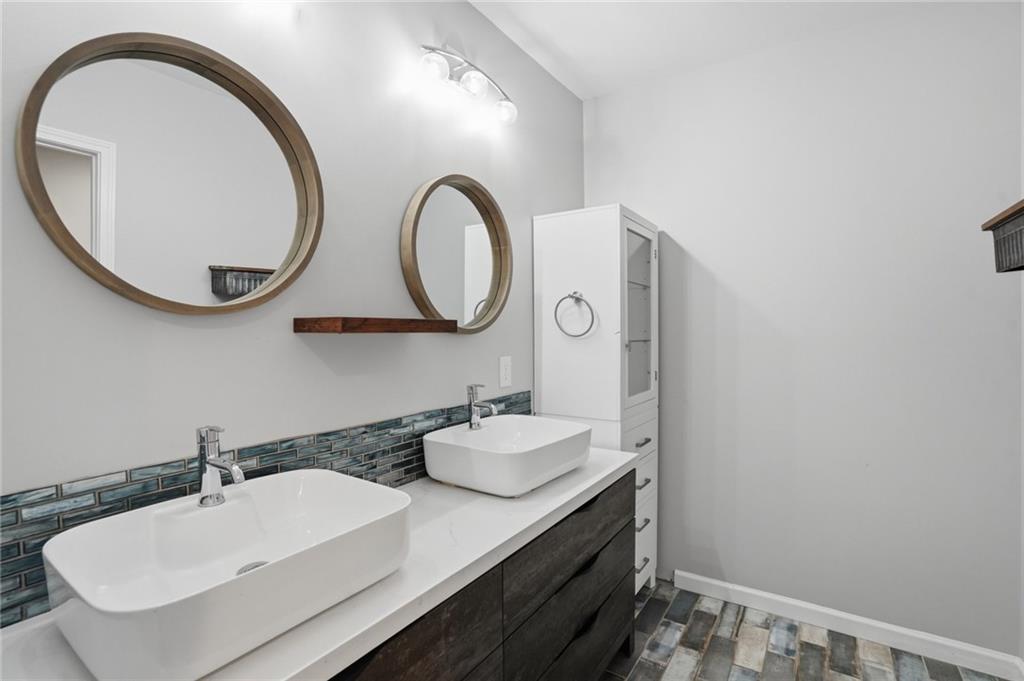 3664 McEver Lake Road Pendergrass, GA 30567 - Photo 26 of 39 a bathroom with a sink and a mirror