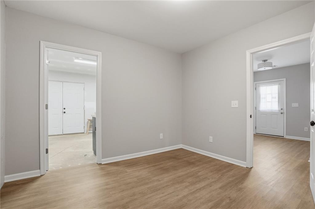 3664 McEver Lake Road Pendergrass, GA 30567 - Photo 29 of 39 an empty room with wooden floor & closet area