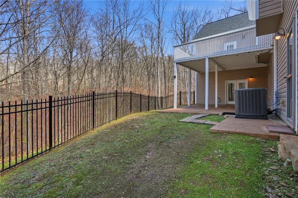 3664 McEver Lake Road Pendergrass, GA 30567 - Photo 35 of 39 a view of a house with a small yard and wooden fence