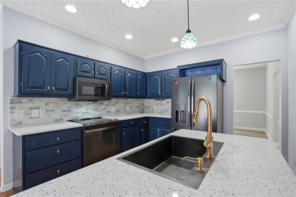 3664 McEver Lake Road Pendergrass, GA 30567 - Photo 5 of 39 a kitchen with stainless steel appliances granite countertop a refrigerator and a sink
