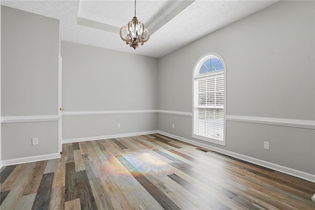 3664 McEver Lake Road Pendergrass, GA 30567 - Photo 10 of 39 wooden floor in an empty room with a window