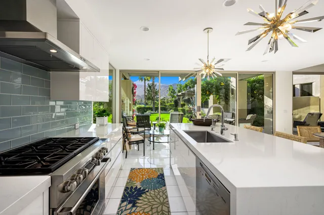 a kitchen with a stove and a dining table