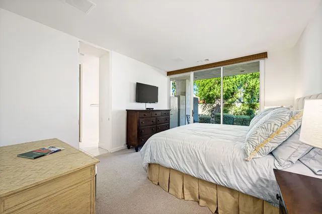 a bedroom with a bed and a television