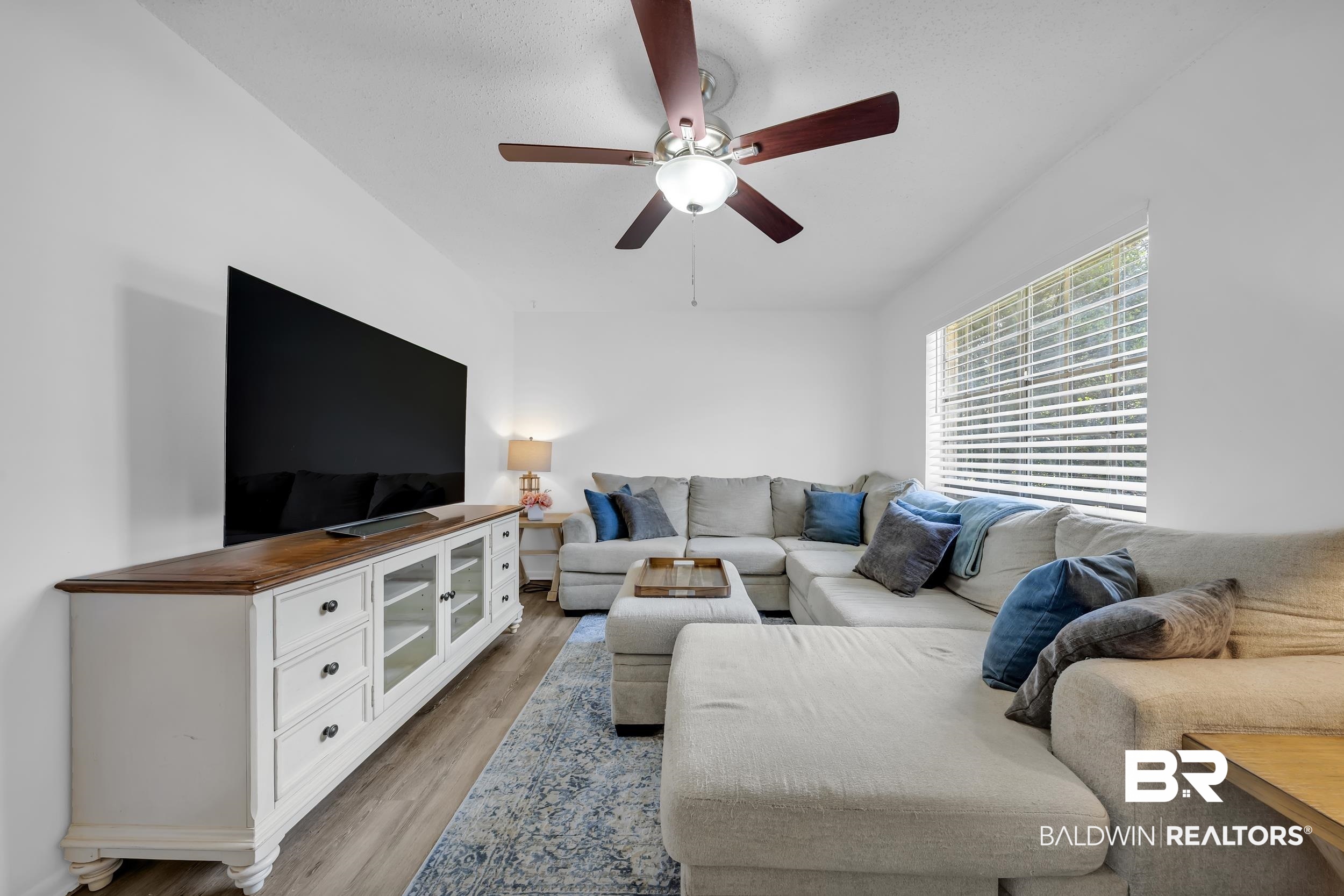 9660 Howells Ferry Road Semmes, AL 36575 - Photo 10 of 23 Living area with light wood-style floors and ceiling fan