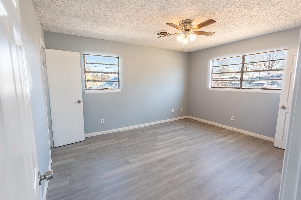 2802 40th Street Lubbock, TX 79413 - Photo 13 of 21 an empty room with wooden floor and windows